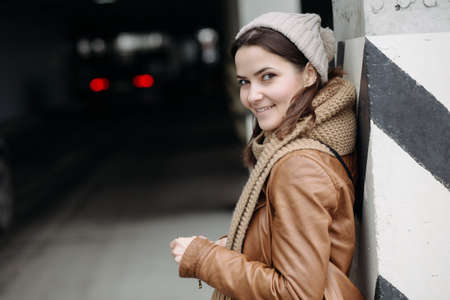 Portrait of young beautiful smiling girl standing in parkingの写真素材