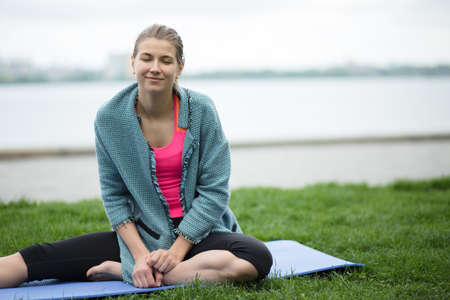 Young sporty woman sitting and relaxing at open air