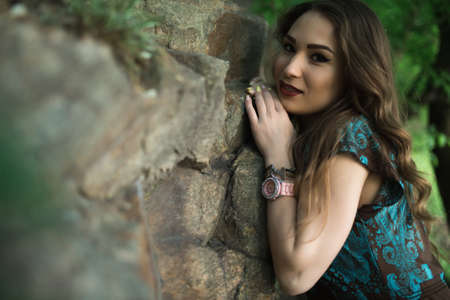 Fine art portrait of sexy woman in dress at the rocksの写真素材