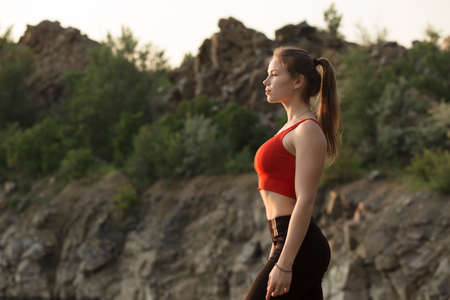 Beautiful sporty woman looking at sunset outdoorの写真素材