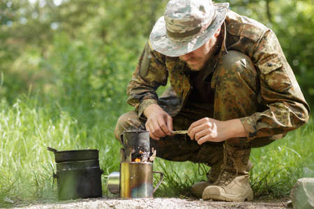 Male tourist prepared dinner on a burnerの写真素材
