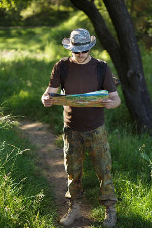 Male explorer looking at a map outdoorsの写真素材