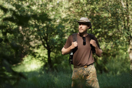 Male tourist walking alone in forest