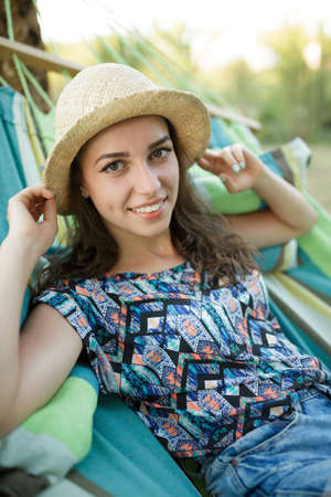 Smiling girl lie on hammock