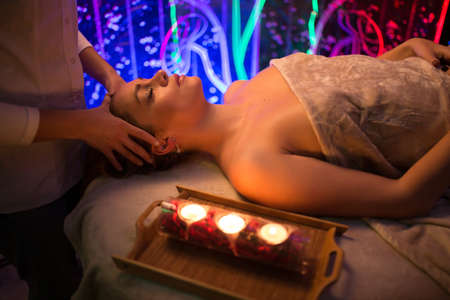 Beautiful relaxed spa procedure by candle lightの写真素材
