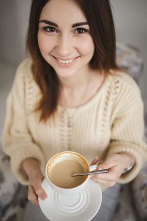 Portrait of woman keep cup of cappuccinoの写真素材