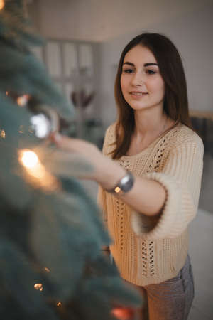 Woman dress up the Christmas treeの写真素材