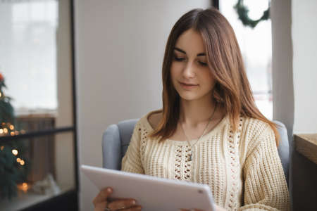 Cute woman using tablet pc in a cafeの写真素材