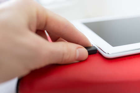 Close-up plugging in USB charging or data cableの写真素材