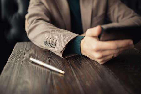 Cropped of businessman using digital tablet in a cafe