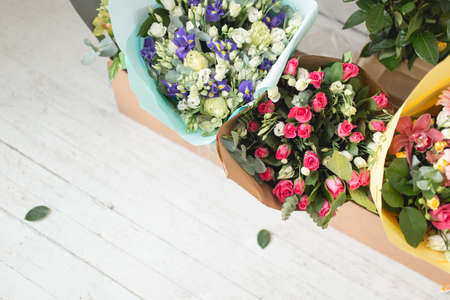 Many different bouquets of flowers on white wooden backgroundの写真素材