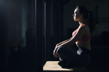 Woman sitting in gym