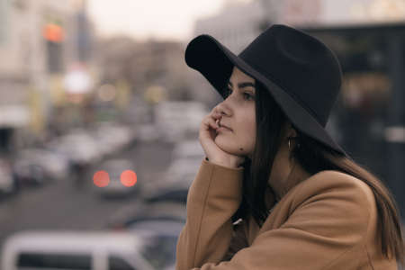 Portrait of woman in hat at city backgroundの写真素材