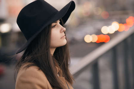 Portrait of woman in hat at city backgroundの写真素材