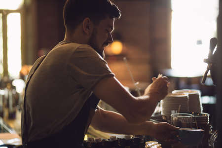 Young male bartender working with love in a barの写真素材