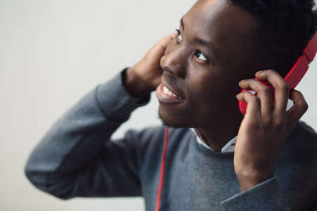 Closeup portrait of african american man listening music with headphones