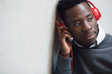 Closeup portrait of african american man listening music with headphones