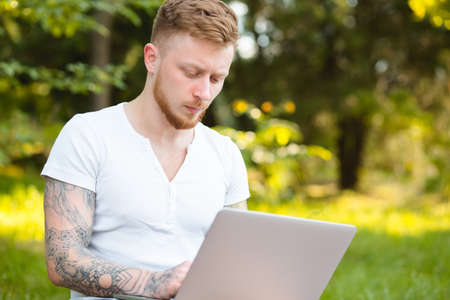 Man freelancer working with laptop in a natureの写真素材