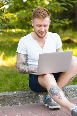 Man freelancer working with laptop in a natureの写真素材