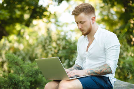 Man freelancer working with laptop in a natureの写真素材
