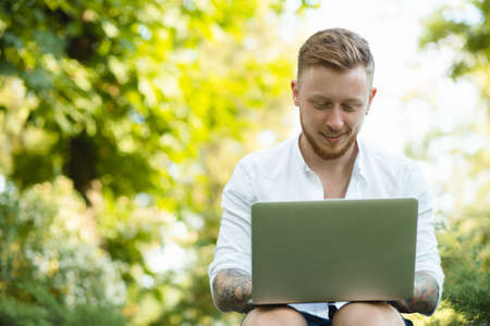 Man freelancer working with laptop in a natureの写真素材