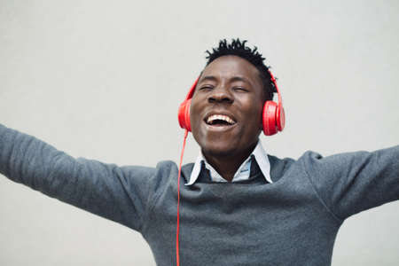 Closeup portrait of african american man enjoy to listening music with headphones and having funの写真素材