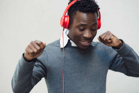 Closeup portrait of african american man enjoy to listening music with headphones and dancingの写真素材