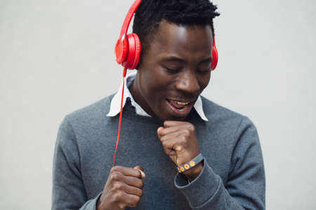 Closeup portrait of african american man enjoy to listening music with headphones and dancingの写真素材
