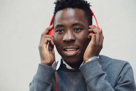 Closeup portrait of african american man listening music with headphonesの写真素材