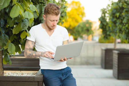 Man freelancer working with laptop outdoorsの写真素材