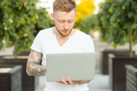 Man freelancer working with laptop outdoorsの写真素材