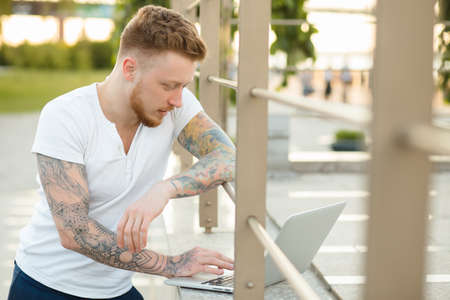 Man freelancer working with laptop outdoorsの写真素材