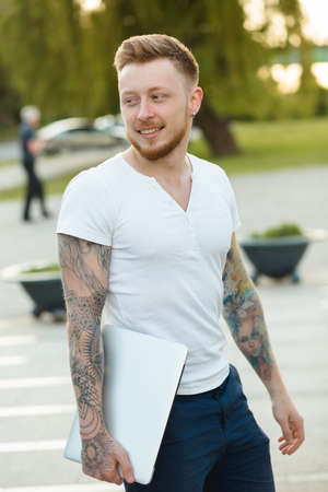 Stylish man with laptop outdoorsの写真素材