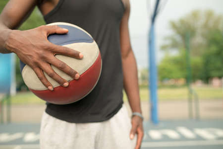 Portrait of african american man on basketball court keep ball