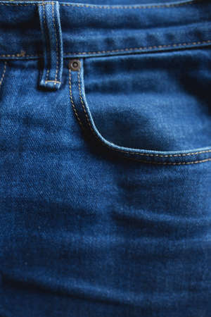 Texture of a denim jeans cloth pants with pocketの写真素材