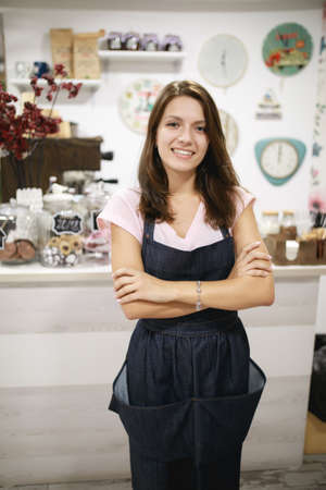 Woman barista portrait at her workplace. She ready to service client.の写真素材