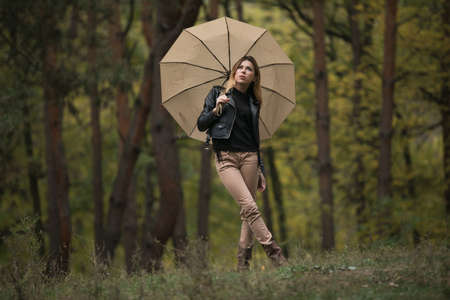 Woman play with umbrella in forestの写真素材