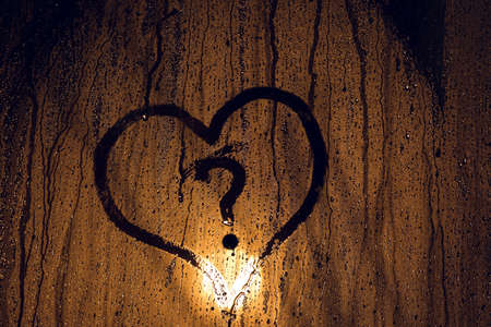 Raindrop texture of heart and question mark. Love or not.の写真素材