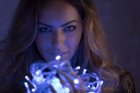 Fantasy woman holding garland, christmas conceptの写真素材