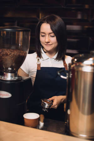 Barista at work preparing coffeeの写真素材