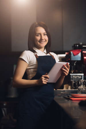 Barista using digital tablet for best maintenance in cafeの写真素材
