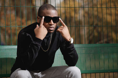 Rich african american man rapper with sunglasses in cityの写真素材