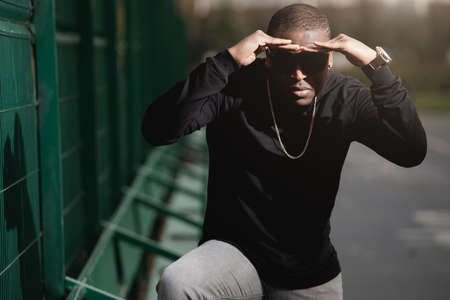Rich african american man rapper with sunglasses in cityの写真素材