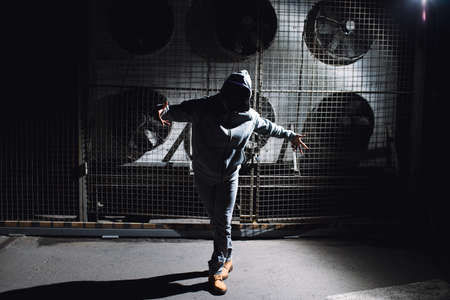 Modern rapper dancing in garage. Urban lifestyle, hip hop.の写真素材