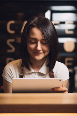 Barista using digital tablet in cafe. Online order.