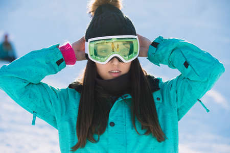 Leisure, sport concept, closeup snowboarder woman in ultraviolet mask