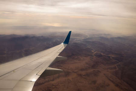 View to Earth landscape through airplane window, mountains of Egyptの写真素材