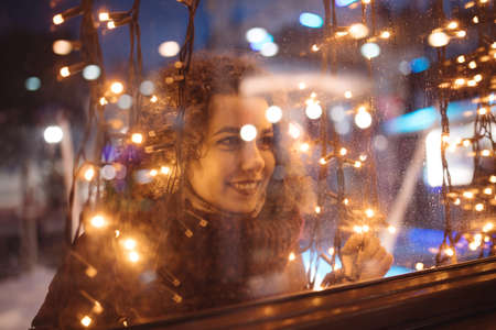 Woman in christmas lightsの写真素材