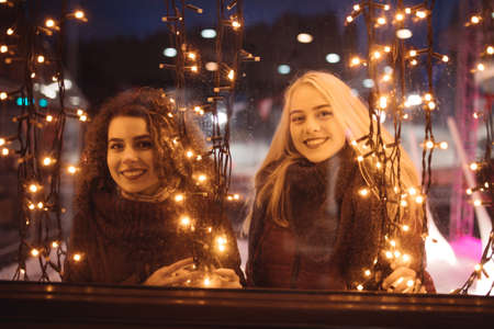 Women in christmas lightsの写真素材