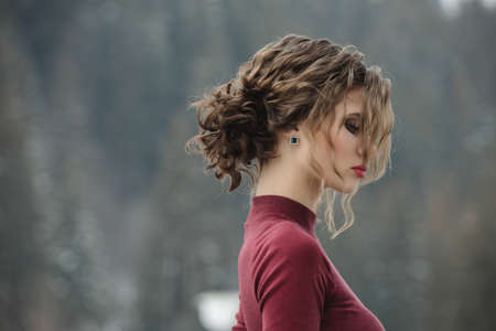 Woman with curly hairstyle at winterの写真素材